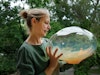 Designerin Simone Lüling mit einem irisierenden Lampenglas
